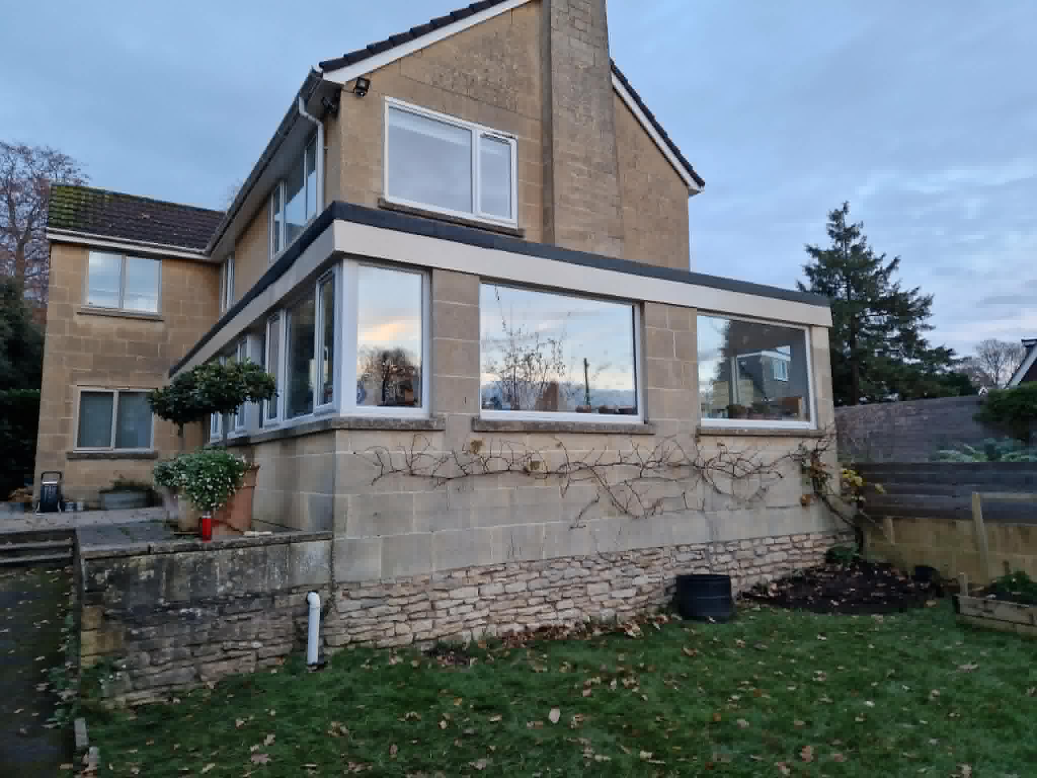 Exterior painting on a Bath stone property — freshly painted window frames and fascias